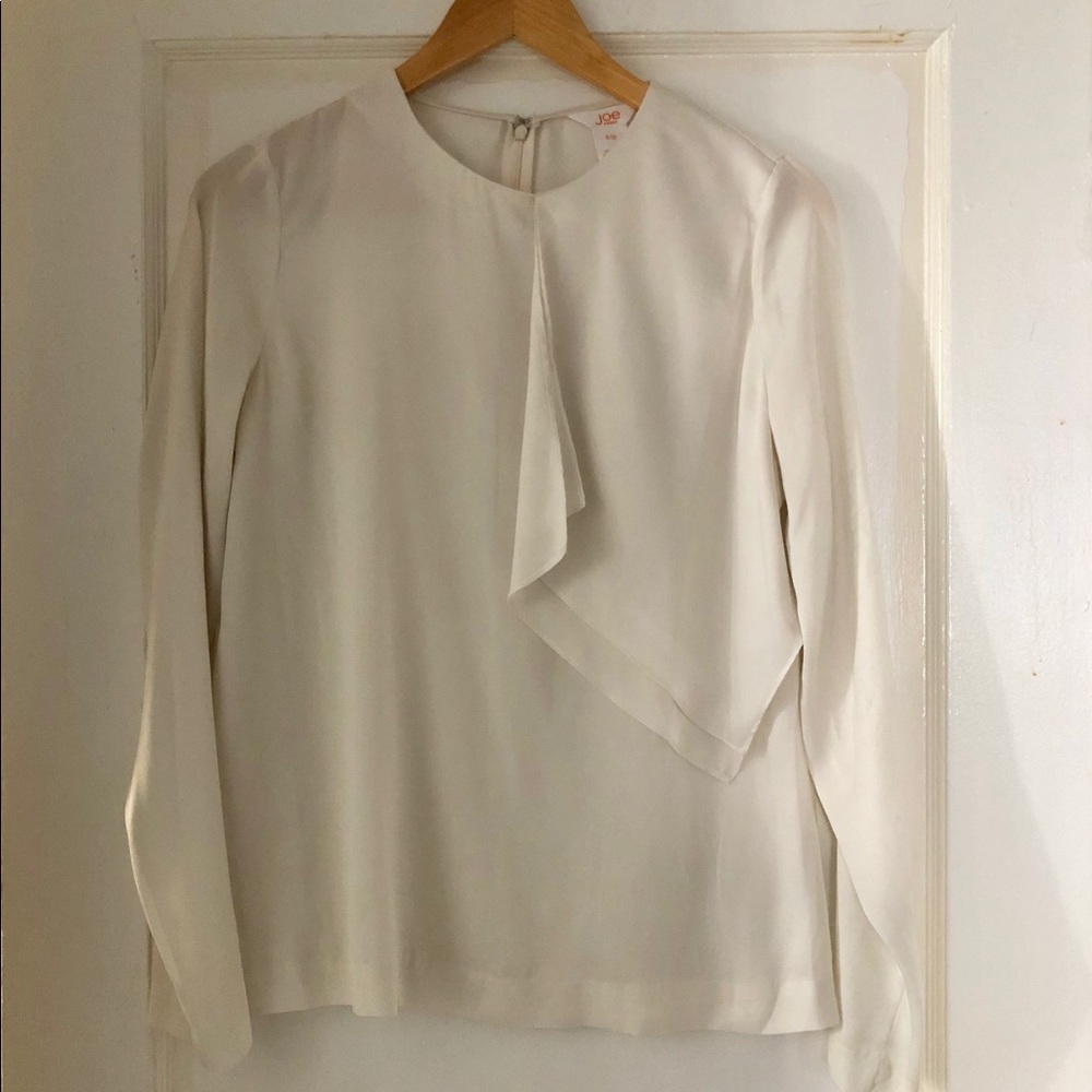 Off-white silky blouse.